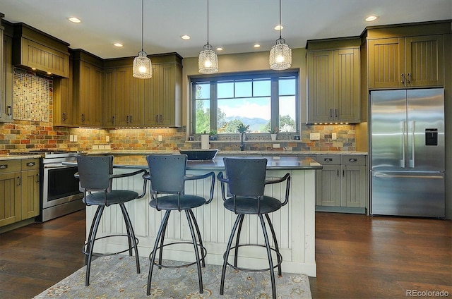 117 River Run Ct, Buena Vista, CO 81211 - kitchen with stainless steel appliances, backsplash, a center island, a breakfast bar, and recessed lighting
