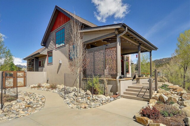 117 River Run Ct, Buena Vista, CO 81211 - view of side of home with stucco siding and a gate