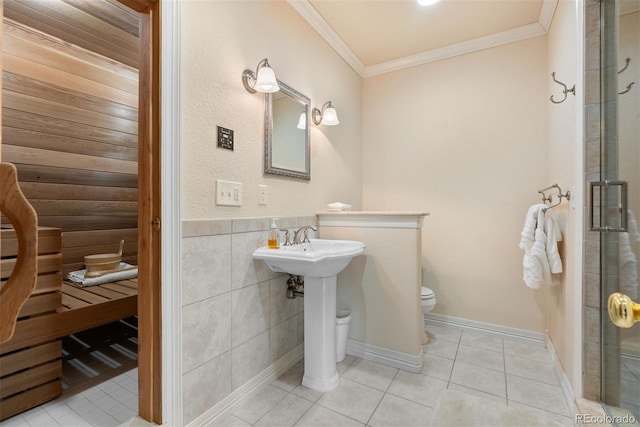 11406 Conifer Ridge Dr, Conifer, CO 80433 - full bathroom featuring ornamental molding, tile patterned floors, toilet, an enclosed shower, and tile walls