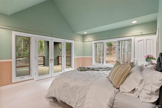 11406 Conifer Ridge Dr, Conifer, CO 80433 - carpeted bedroom featuring access to exterior, wainscoting, french doors, vaulted ceiling, and wooden walls