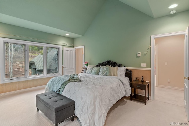 11406 Conifer Ridge Dr, Conifer, CO 80433 - carpeted bedroom featuring wooden walls, a wainscoted wall, and high vaulted ceiling