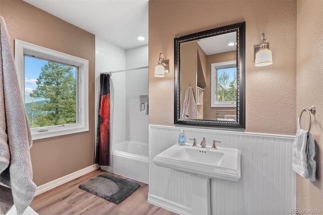 11406 Conifer Ridge Dr, Conifer, CO 80433 - full bath featuring wood finished floors, healthy amount of natural light, shower / tub combo, and a wainscoted wall