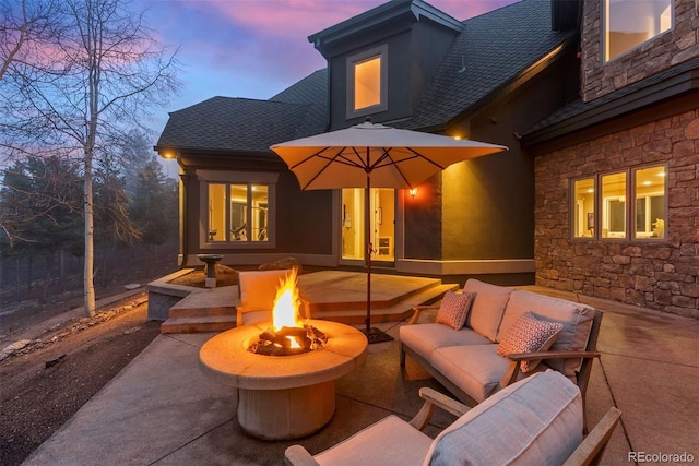 11406 Conifer Ridge Dr, Conifer, CO 80433 - patio terrace at dusk featuring an outdoor living space with a fire pit