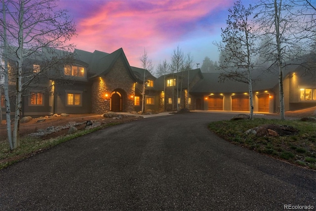 11406 Conifer Ridge Dr, Conifer, CO 80433 - traditional-style home featuring stone siding and curved driveway