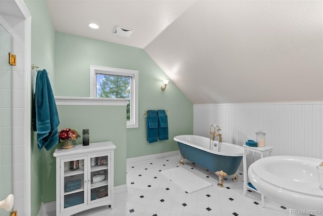 11406 Conifer Ridge Dr, Conifer, CO 80433 - full bath with a freestanding tub, lofted ceiling, and baseboards