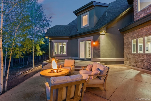 11406 Conifer Ridge Dr, Conifer, CO 80433 - patio terrace at dusk featuring a patio and an outdoor living space with a fire pit