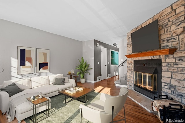 living room with a fireplace and wood-type flooring