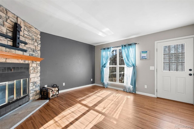 unfurnished living room featuring a fireplace and hardwood / wood-style flooring