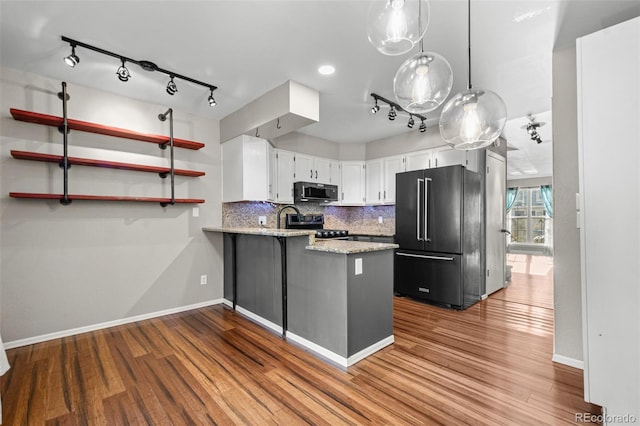 kitchen featuring white cabinets, kitchen peninsula, light hardwood / wood-style flooring, and high end fridge