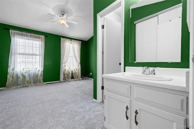 bathroom with vanity, a textured ceiling, and ceiling fan