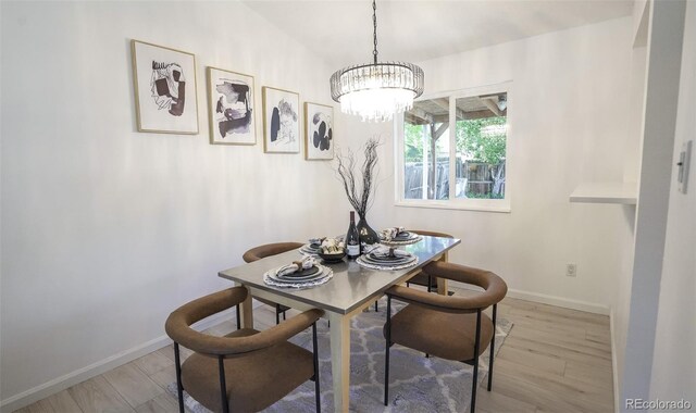 13833 W 68th Ave, Arvada, CO 80004 - dining room with light wood-style floors, baseboards, and a chandelier