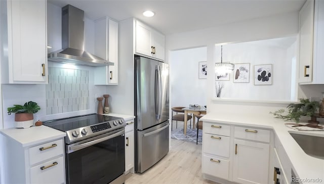13833 W 68th Ave, Arvada, CO 80004 - kitchen featuring appliances with stainless steel finishes, wall chimney range hood, white cabinets, backsplash, and recessed lighting