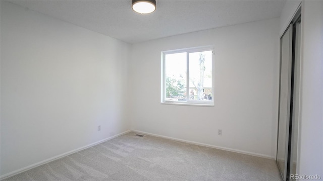 13833 W 68th Ave, Arvada, CO 80004 - unfurnished bedroom featuring light carpet, baseboards, and a closet