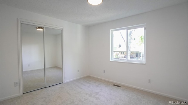 13833 W 68th Ave, Arvada, CO 80004 - unfurnished bedroom with carpet, baseboards, a closet, and a textured ceiling