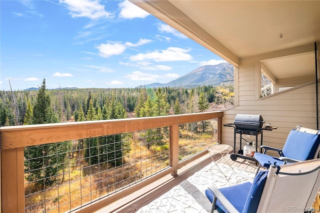 balcony featuring a mountain view and a grill