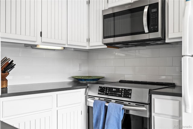 kitchen featuring white cabinetry, appliances with stainless steel finishes, and tasteful backsplash