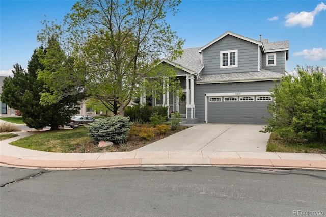 3618 Boot Spur Ct, Colorado Springs, CO 80922 - view of front facade featuring driveway, a shingled roof, and a garage