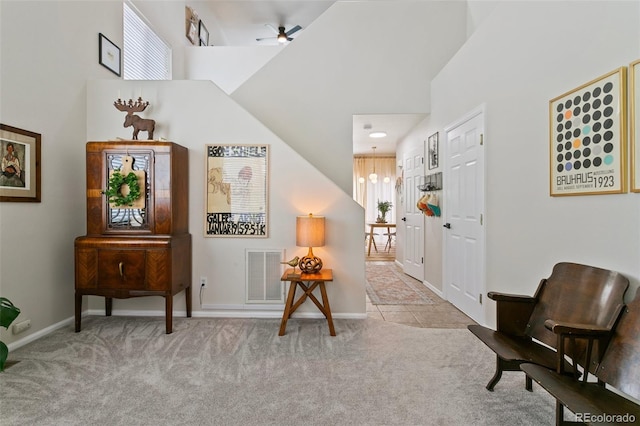 3618 Boot Spur Ct, Colorado Springs, CO 80922 - sitting room featuring carpet flooring, ceiling fan, a high ceiling, and baseboards