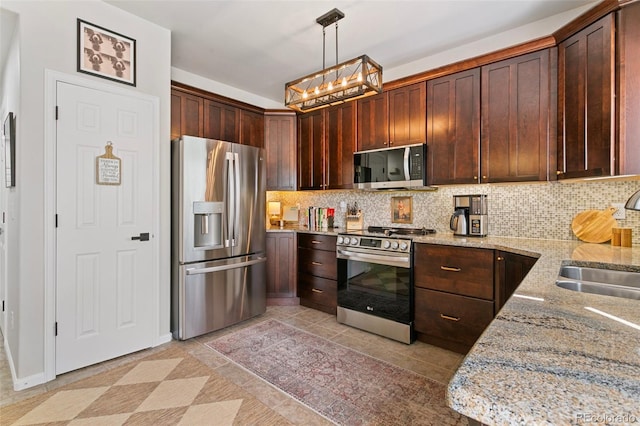 3618 Boot Spur Ct, Colorado Springs, CO 80922 - kitchen featuring stainless steel appliances, a sink, backsplash, and light stone countertops