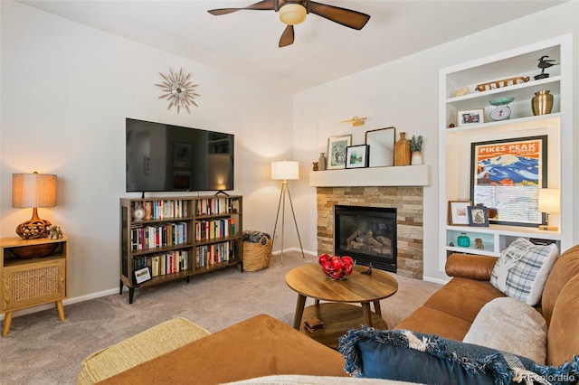 3618 Boot Spur Ct, Colorado Springs, CO 80922 - living room with carpet flooring, ceiling fan, a fireplace, and baseboards