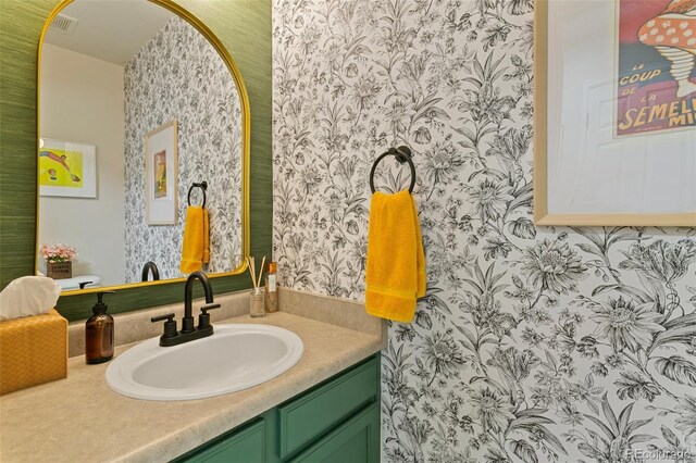 3618 Boot Spur Ct, Colorado Springs, CO 80922 - bathroom with wallpapered walls and vanity