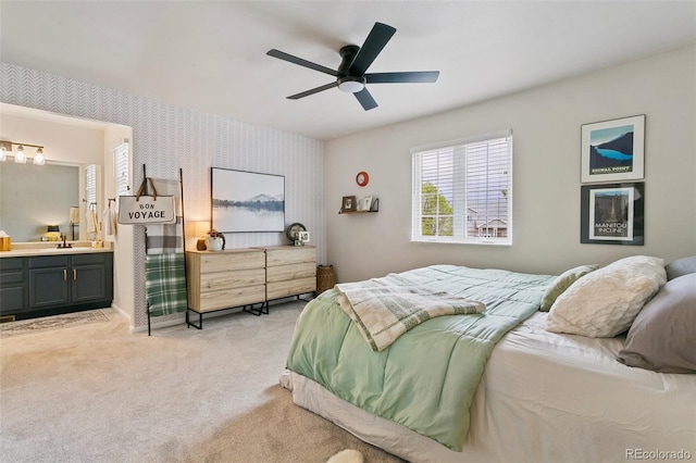 3618 Boot Spur Ct, Colorado Springs, CO 80922 - bedroom featuring wallpapered walls, light colored carpet, ensuite bath, a ceiling fan, and baseboards