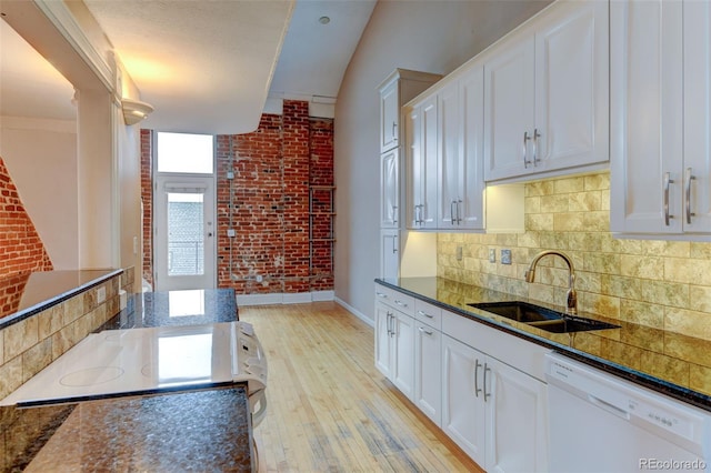 kitchen featuring white cabinetry, white dishwasher, and sink