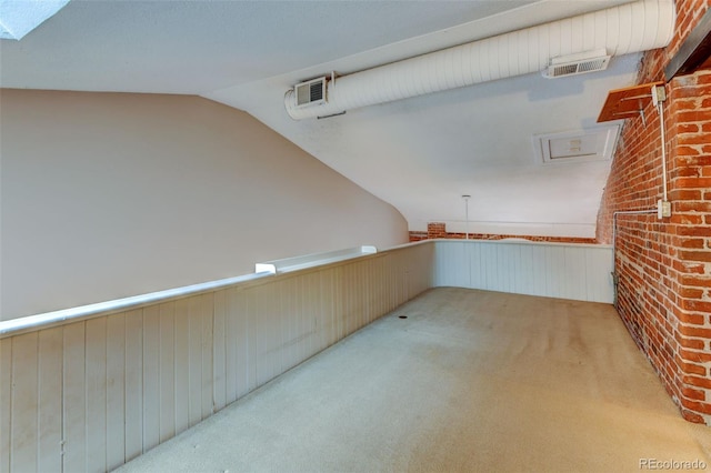 basement featuring light colored carpet and wooden walls