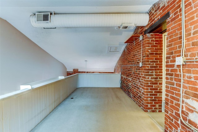 interior space with brick wall and wood walls