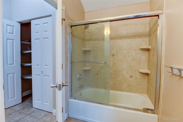 bathroom featuring tile patterned flooring and combined bath / shower with glass door