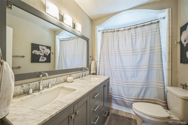 7340 W 32nd Ave, Wheat Ridge, CO 80033 - full bathroom with double vanity, a shower with curtain, and a textured wall