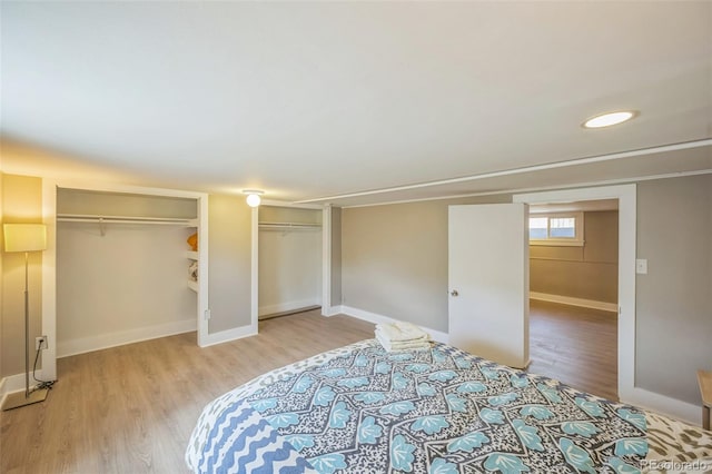 7340 W 32nd Ave, Wheat Ridge, CO 80033 - unfurnished bedroom featuring two closets and light wood-style flooring