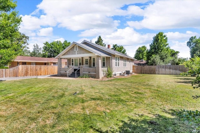 7340 W 32nd Ave, Wheat Ridge, CO 80033 - back of house with a porch, a fenced backyard, and brick siding