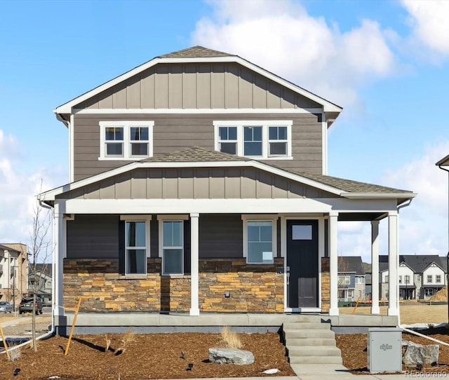 22203 E 6th Pl, Aurora, CO 80018 - view of front of home with a porch, stone siding, and roof with shingles