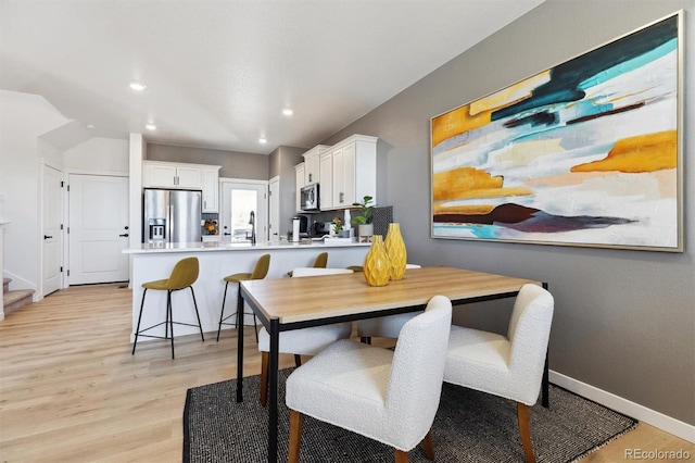 22203 E 6th Pl, Aurora, CO 80018 - dining space featuring light wood-type flooring, recessed lighting, baseboards, and stairs