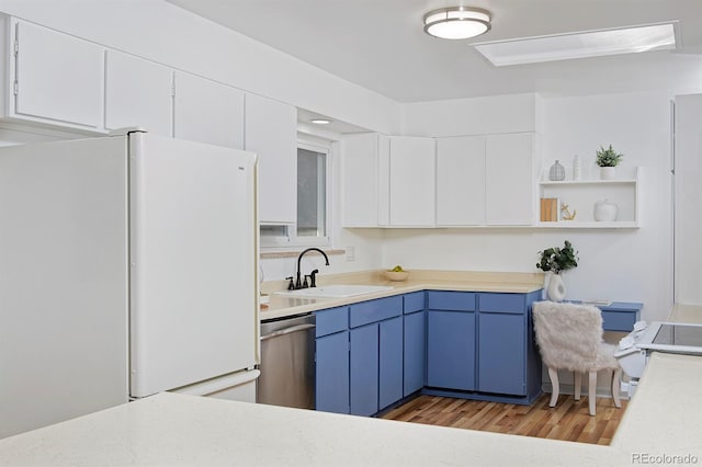 kitchen with freestanding refrigerator, light countertops, blue cabinets, and dishwasher