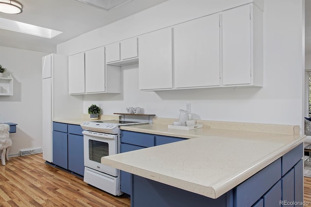 kitchen featuring visible vents, light countertops, blue cabinets, and white range with electric cooktop