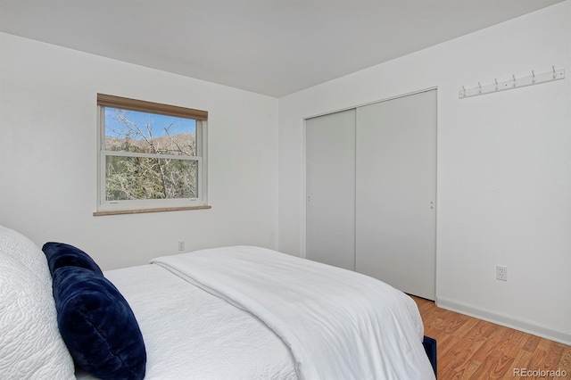 bedroom with a closet and light wood-style flooring