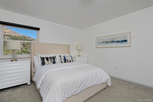 bedroom with baseboards and carpet flooring
