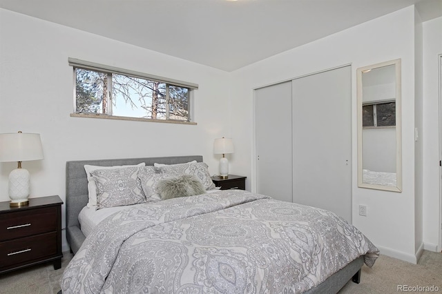 carpeted bedroom with baseboards and a closet