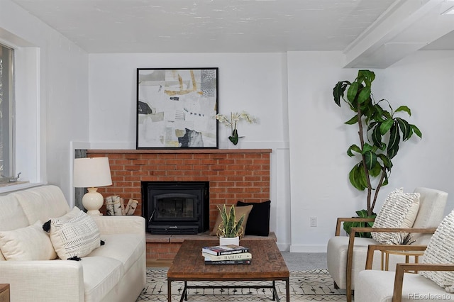 living room with baseboards and a fireplace