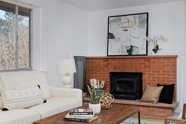 living room with a fireplace and wood finished floors