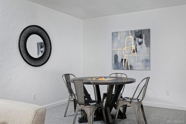 dining room with baseboards and carpet