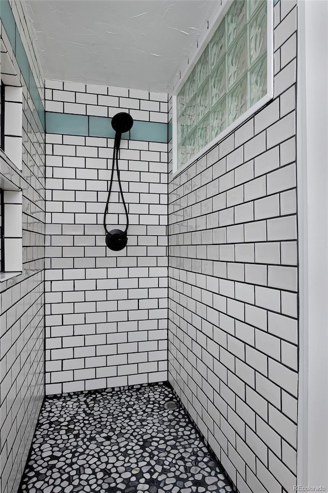 bathroom with a tile shower