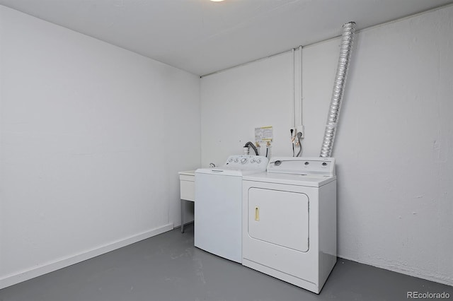 washroom featuring separate washer and dryer and laundry area