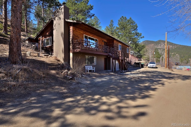 exterior space featuring concrete driveway and a mountain view