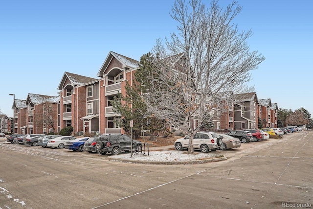 view of building exterior with uncovered parking