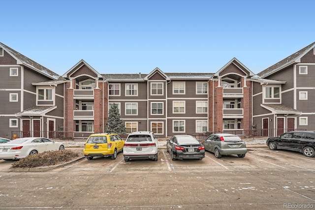 view of building exterior featuring uncovered parking