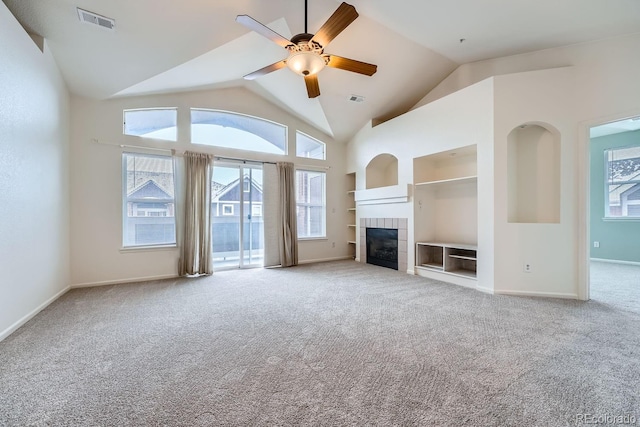 unfurnished living room with built in shelves, a fireplace, visible vents, carpet flooring, and baseboards