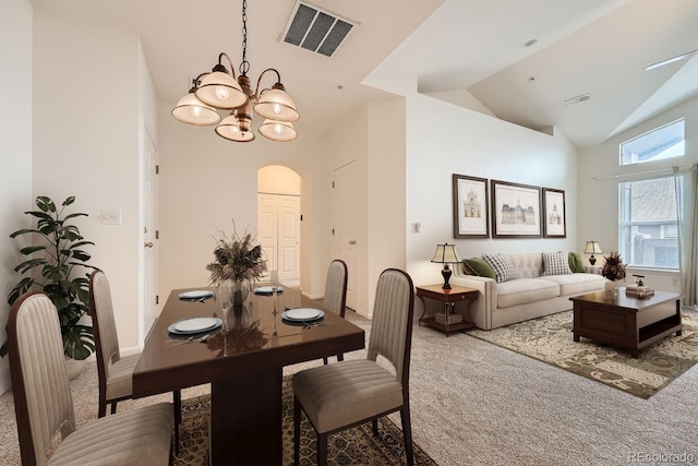 dining room featuring carpet floors, high vaulted ceiling, visible vents, and a notable chandelier